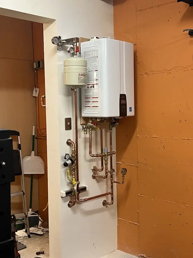 Plumbing technician inspecting water heater connections in Atlantic City